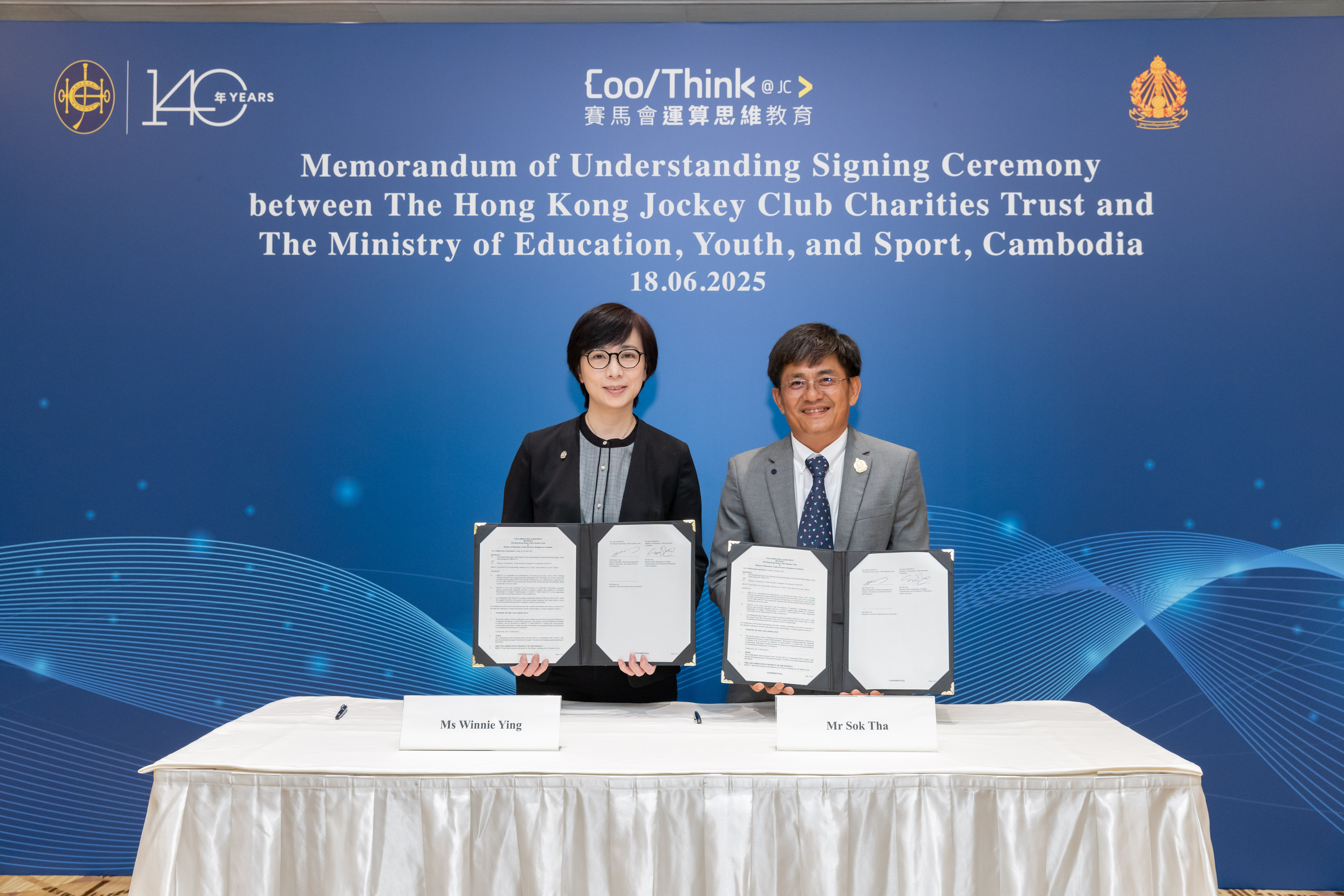 Ms Winnie Ying, Head of Charities (Youth Development & Poverty Alleviation; and Talent & Sector Development), The Hong Kong Jockey Club, and Mr Sok Tha, Director, Department of Digital Transformation, Ministry of Education, Youth, and Sport of Cambodia, sign an MOU for the adoption and adaptation of CoolThink@JC’s curriculum and education model in Cambodian primary schools.