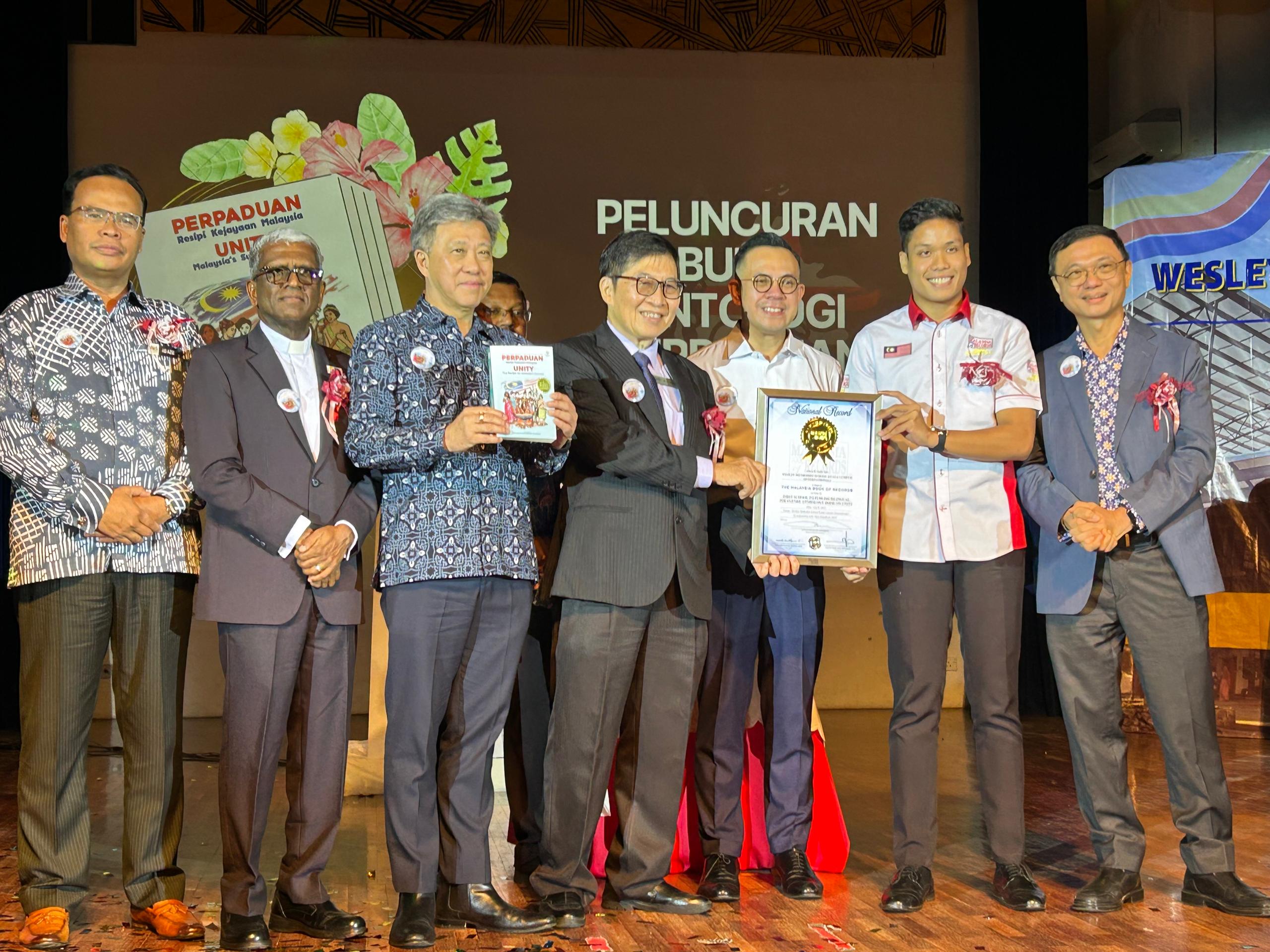WMSKLI representatives receiving the official Malaysia Book of Records certificate on stage during the celebration event